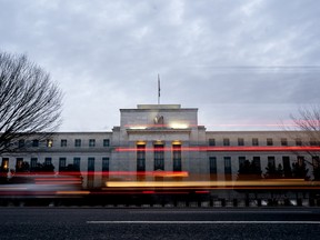 Vehicles drive past the Marriner S. Eccles Federal Reserve building in Washington, D.C.